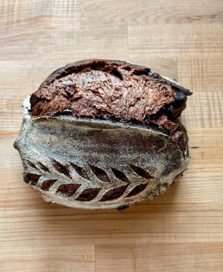 Double chocolate sourdough batard, cut to show the dark crumb
